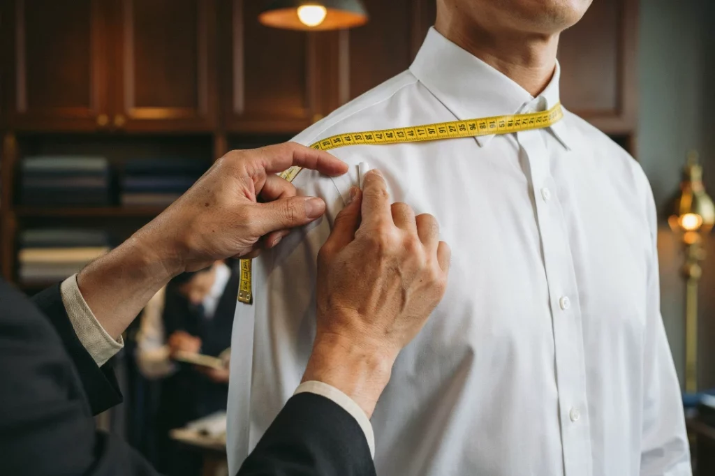 Best tailors near Asok BTS measuring client in Sukhumvit Soi 10-23 showroom